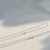Thin sterling silver chain necklace laid flat, showcasing its delicate design and polished silver finish against a neutral background.