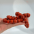 Stretch bracelets made of smooth, round, reddish-orange dyed howlite gemstone beads with dark, natural veining.