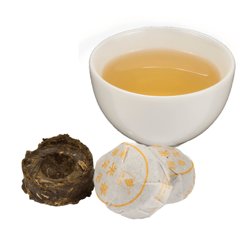 cup of tea with pressed tea in and out of wrappers