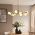 Aaron 10 Light Brushed Aged Brass with Matt Opal Spheres Pendant Light