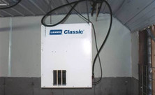 L.B. White Classic forced-air heater suspended in a swine building; representative installation