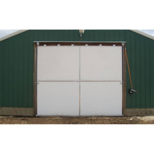 White L.B. White insulated bi-fold door closed on an agricultural building — representative installation