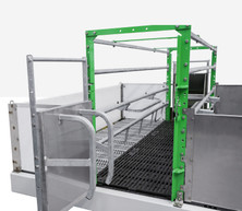 Angled view of Crystal Spring Next Generation farrowing crate with green frame and slatted flooring