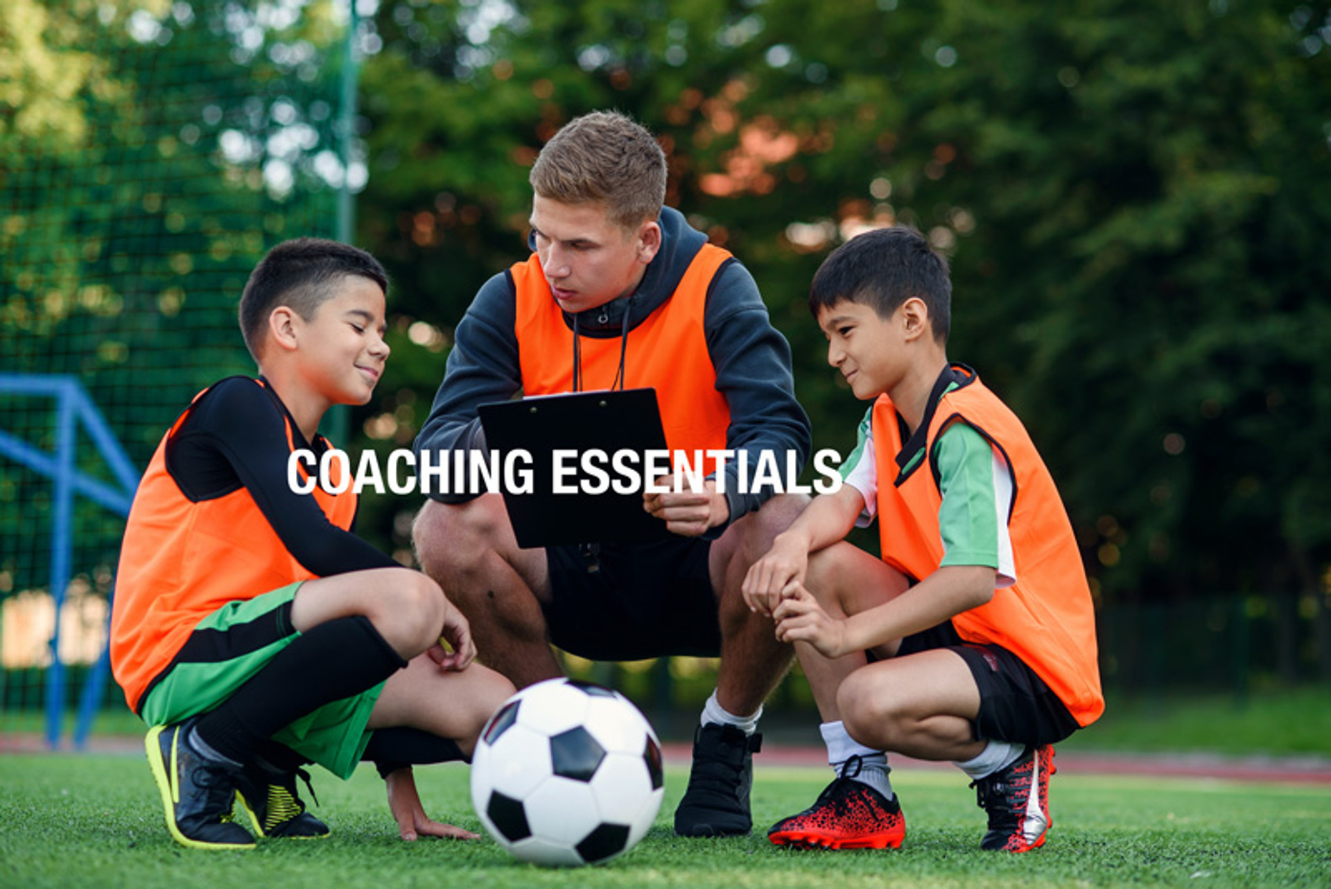 Soccer coach with young players using size 3 soccer ball