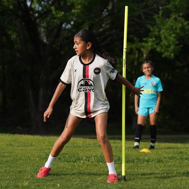 Soccer practice with yellow agility poles