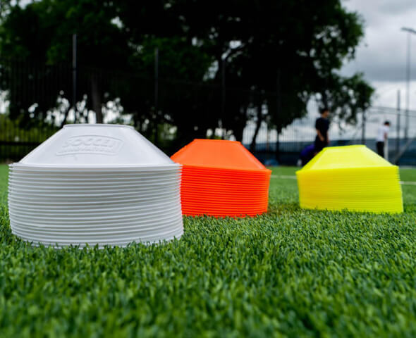 Affordable disc cones stacked on turf for budget-friendly soccer drills