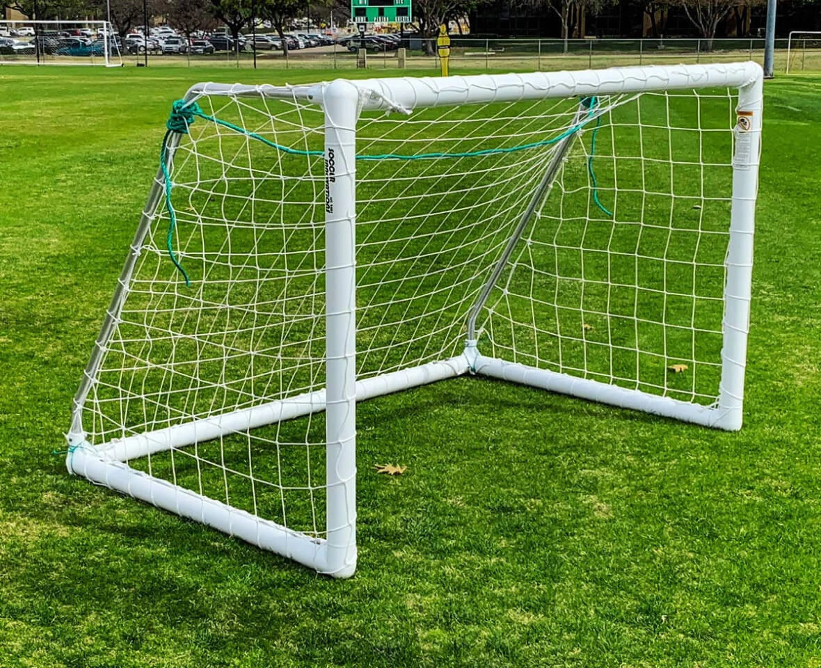Soccer Innovations portable soccer goal with white frame and net on an outdoor grass field