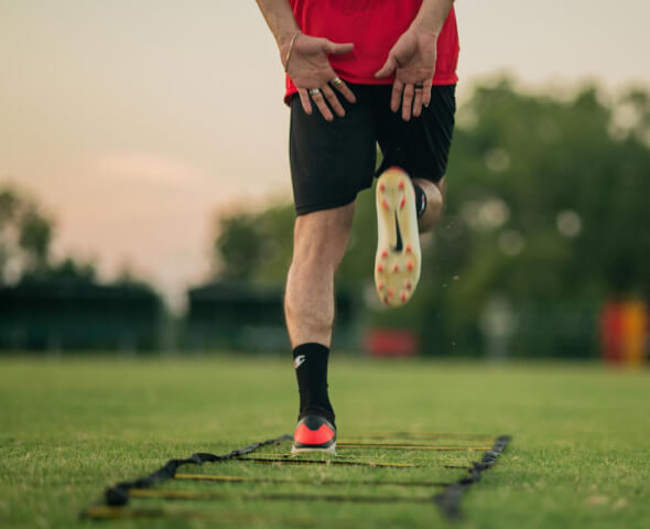 Agility hurdles, disc and match ball arranged for intensive field conditioning