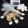 The supplies included in the kit on display with the corn seeds germinated on cotton balls.