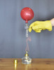 An alcohol lamp heating up a test tube with a balloon on the top of the tube.