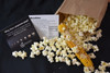 Popped popcorn with the dried popcorn cob and the instructions.