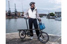 Woman stood behind Brompton bike