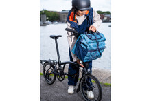 Woman attaching bag to Brompton Bike