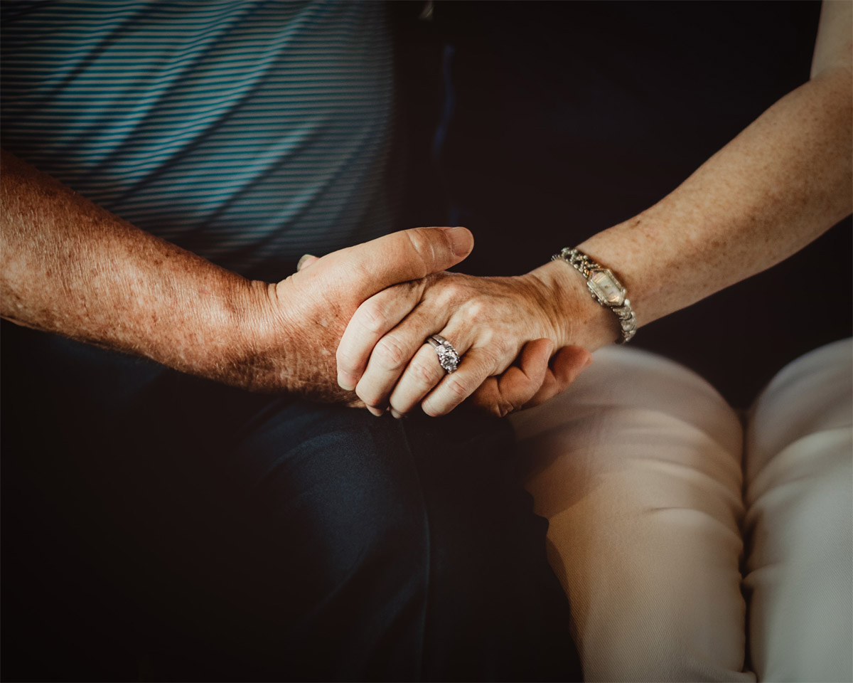 older couple holding hands