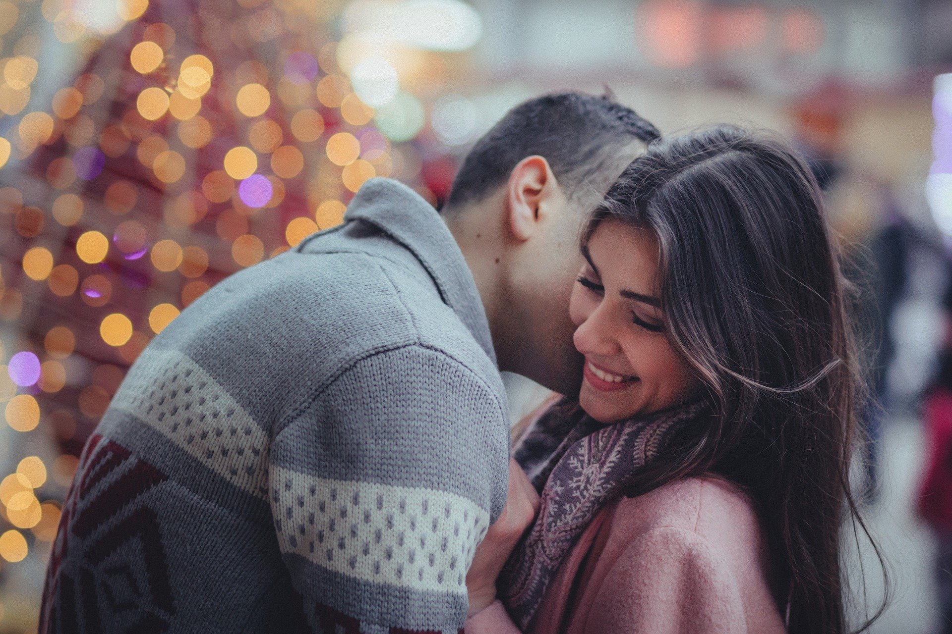 couple kissing at Christmas tree