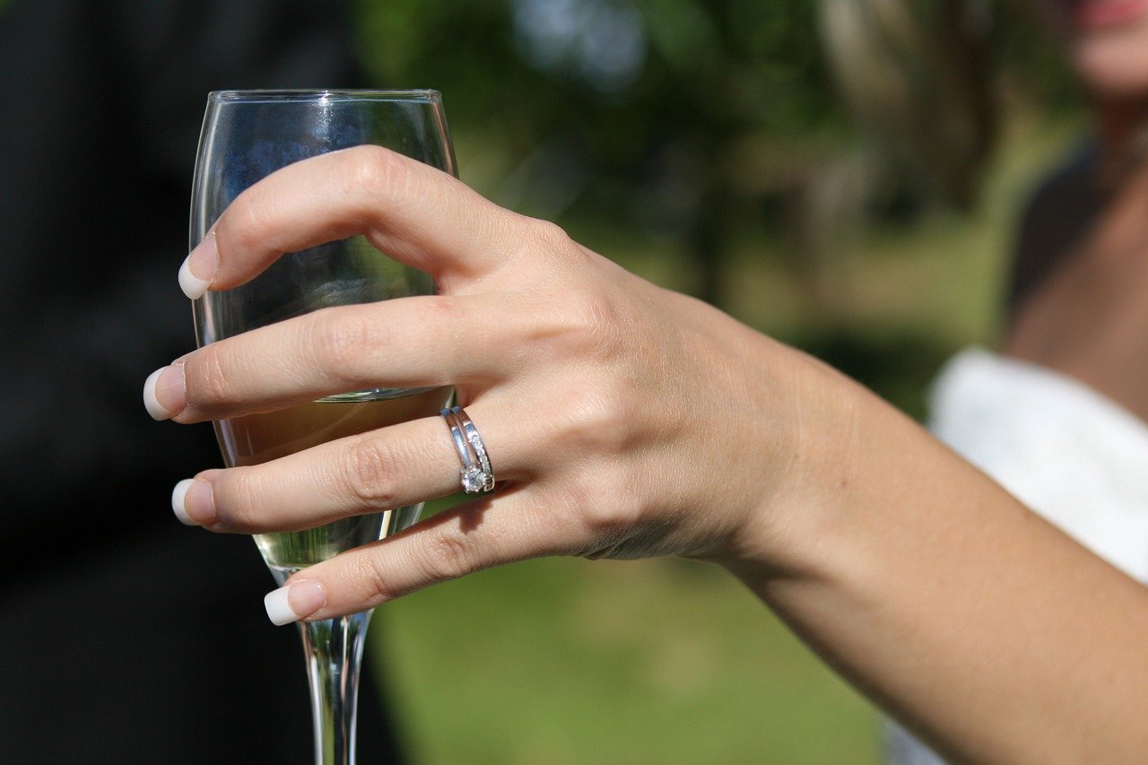 woman with bridal set holding champagne