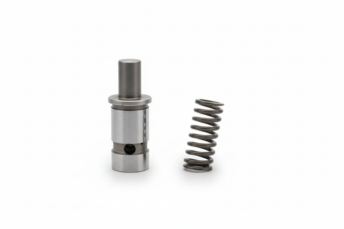 Improved relief valve and spring kit KMW05806295 replaces the factory relief components in the 3710 backhoe valve block on 2615 tractors, increasing flow under load to speed up backhoe cycle times while maintaining proper system protection.