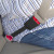 Black, rigid Audi 90 Seat Belt Extender buckled around a plus-sized passenger