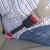 Black, rigid Audi RS7 Seat Belt Extender buckled around a plus-sized passenger