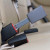 Gray, rigid GEO Storm five-inch extender buckled into the back seat of a vehicle and standing upright (gray color has limited availability)