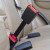 Black, rigid Honda CR-V seven-inch extender buckled into the back seat of a vehicle and standing upright