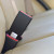 Black, rigid Fiat 500 three-inch seat belt extender buckled into the back seat