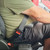 Black, rigid Volvo Truck Seat Belt Extender buckled around a plus-sized passenger side view