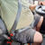 Black, rigid Volvo Truck Seat Belt Extender buckled around a plus-sized passenger front side view