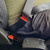 Black, rigid Volvo Truck Seat Belt Extender buckled around a plus-sized passenger