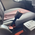 Black, rigid GMC Sierra 3500 HD Chassis Cab seven-inch extender buckled into the driver's seat of a vehicle and standing upright