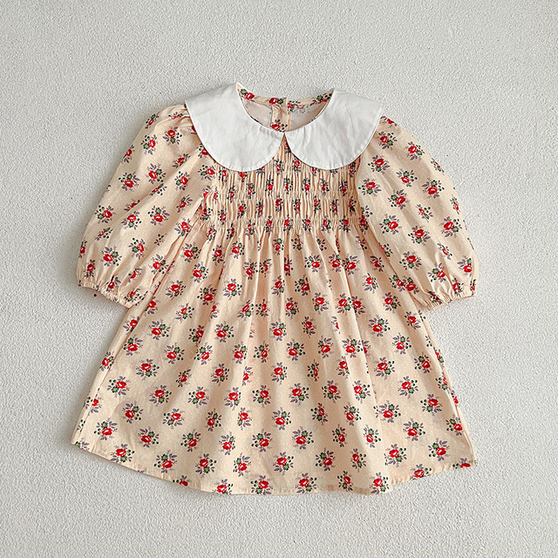 Traditional long sleeved smocked cream and red floral toddler dress