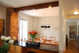 Minimalist Dining Room with a Solo Ceiling Beam