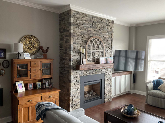 Universal stacked stone outside corners shown with Colorado Dry Stack panels in Mist and a Timber Faux Wood mantel in Rich Walnut.-thumb