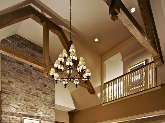 Heavy Sandblasted Faux Wood beams in rich walnut used as decorative trusses in this cathedral ceiling living room.