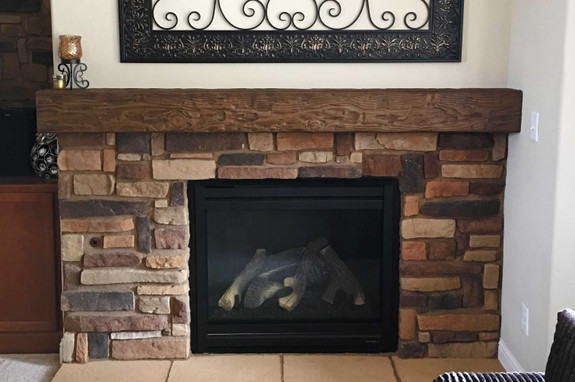 Fireplace decorated with our Tuscany Faux wood mantel in our caramel color.
