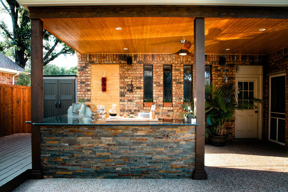 An outdoor kitchen featuring faux stone panels.