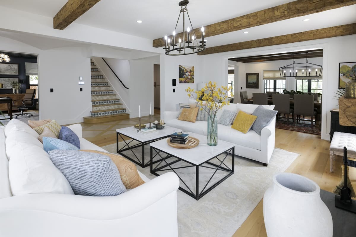 Rough Hewn Faux Wood Beams in Caramel installed on an elegant transitional-style living room ceiling.