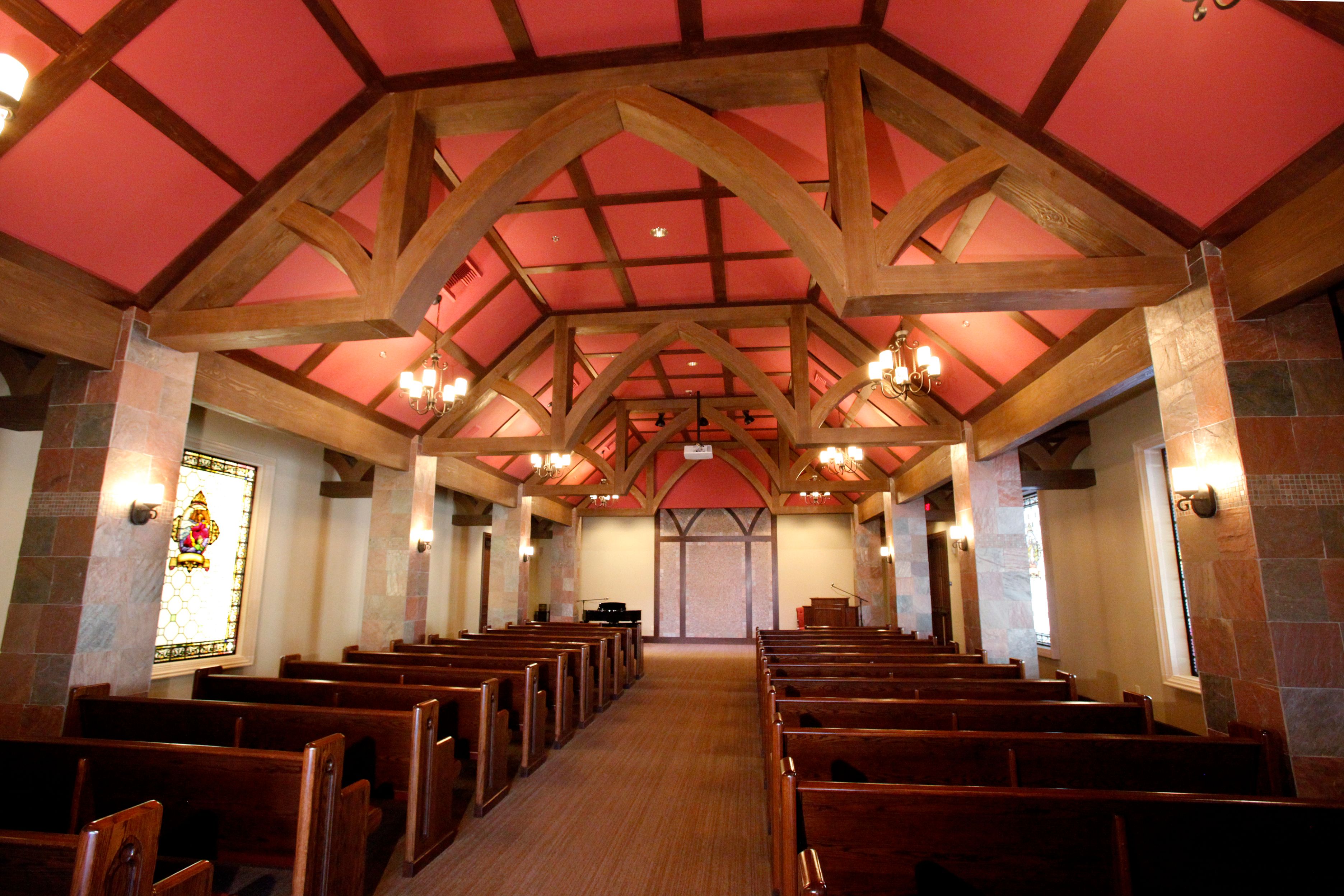 Church with faux wood beams and faux wood truss on the interior