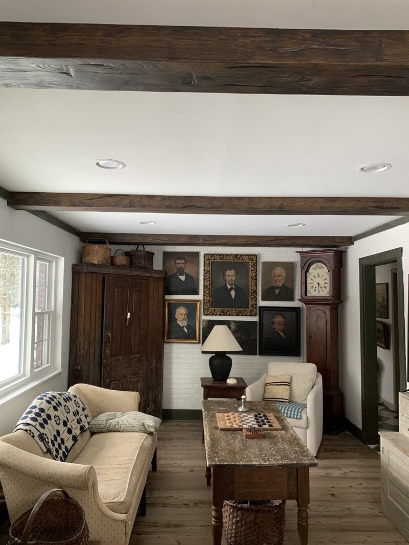 Hand Hewn Faux Wood Beams in Dark Walnut installed on an urban-industrial living room ceiling.