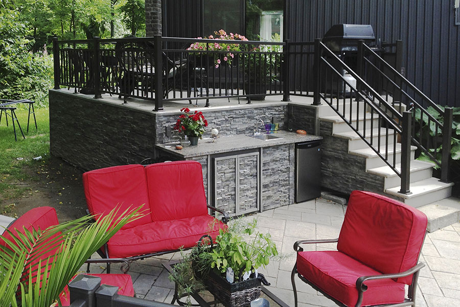 Novi Dry Stack in Anthracite faux panels add the finishing touch to the foundations of a raised patio.