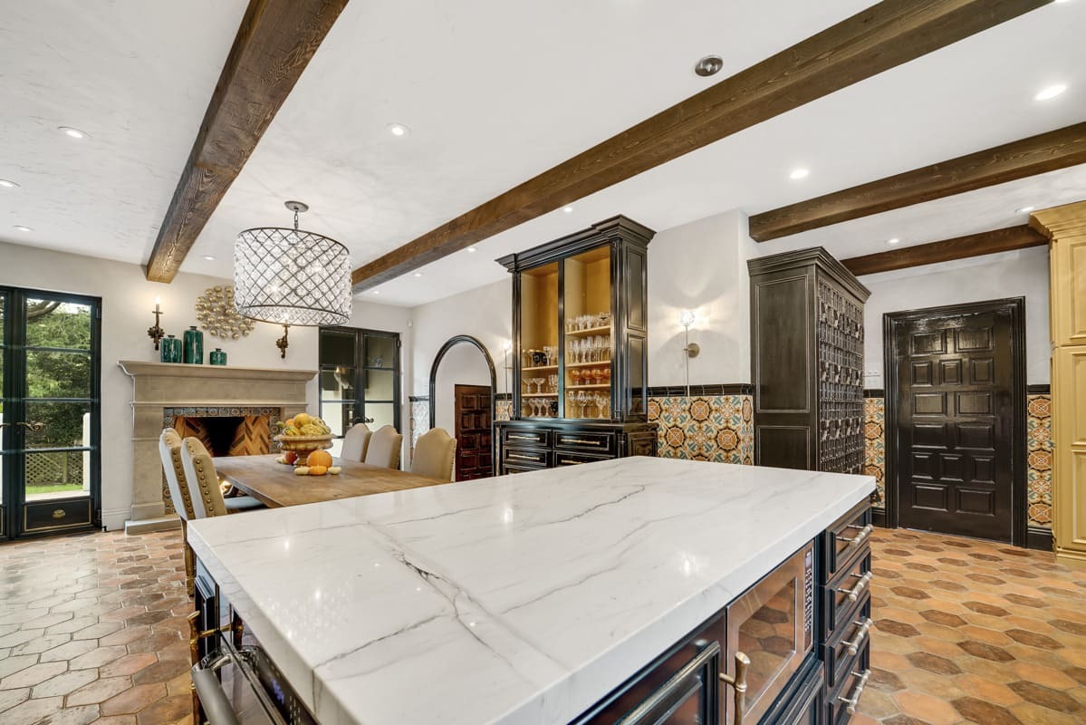 Hand Hewn Faux Wood Beams that were finished by the customer installed on an urban style kitchen and dining area ceiling.