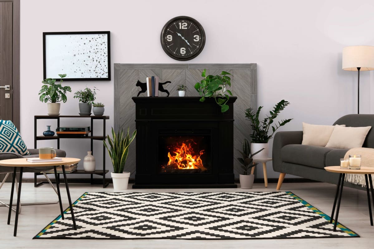 Chevron Faux Wood Wall Panels in Graphite Lead installed as a fireplace surround for an urban-style living space.