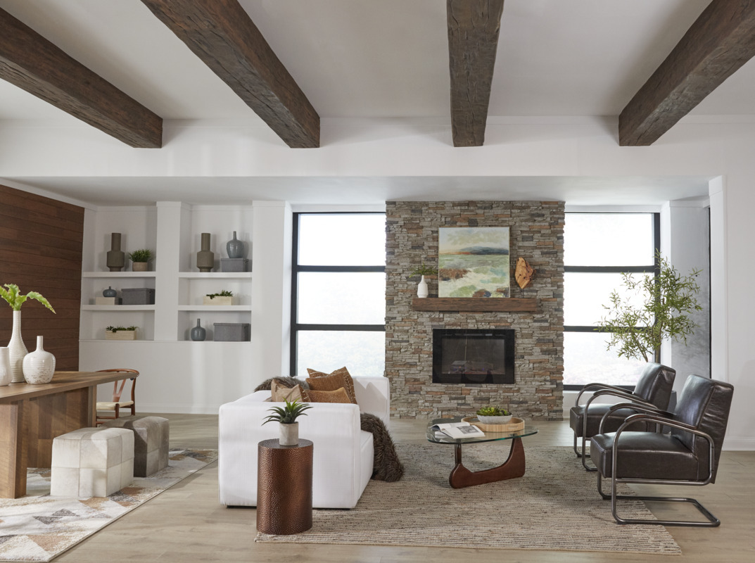 Colorado Dry Stack Faux Stone Panels in Motley Gray and Timber Faux Wood Beams in Rich Walnut for a modern farmhouse-inspired living room