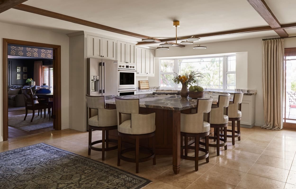 Driftwood Faux Wood Beams in Rich Walnut installed on a traditional style kitchen ceiling.