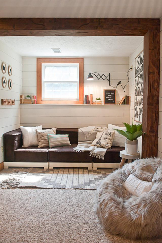 Hand Hewn Faux Wood Beams in Rich Walnut installed on the ceiling and wall for a boho style sitting room design.