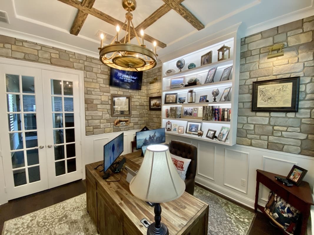  Hampton Cobblestone Faux Stone Wall Panels in Summer Tan installed on the walls in an urban-style home office.