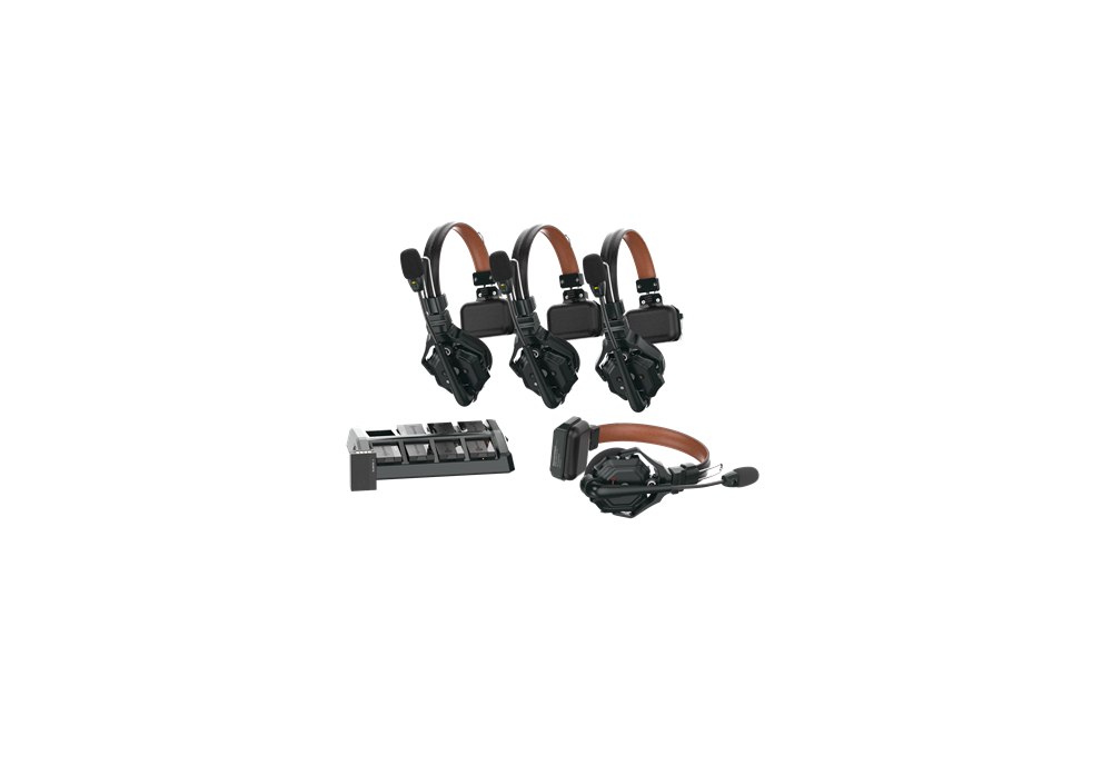 Four Solidcom C1 Pro wireless headsets with their charging tray.