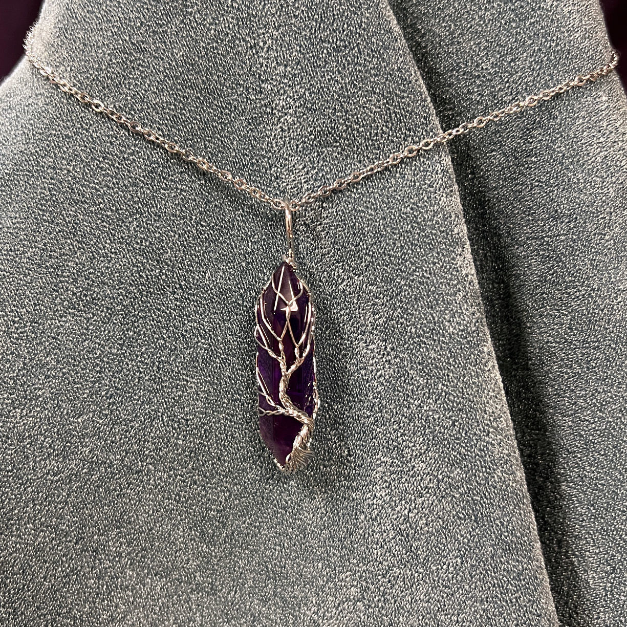 Amethyst crystal wrapped with wire in a tree Tree of Life design, hangs from 19" silver chain with 1/4" bale