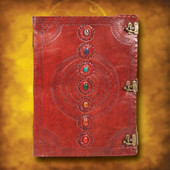 oversized journal is embossed brown leather, front is adorned with seven chakra stones and three antiqued brass metal latches