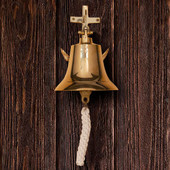polished solid brass bell with anchor-shaped wall mount bracket and rich clear tone
